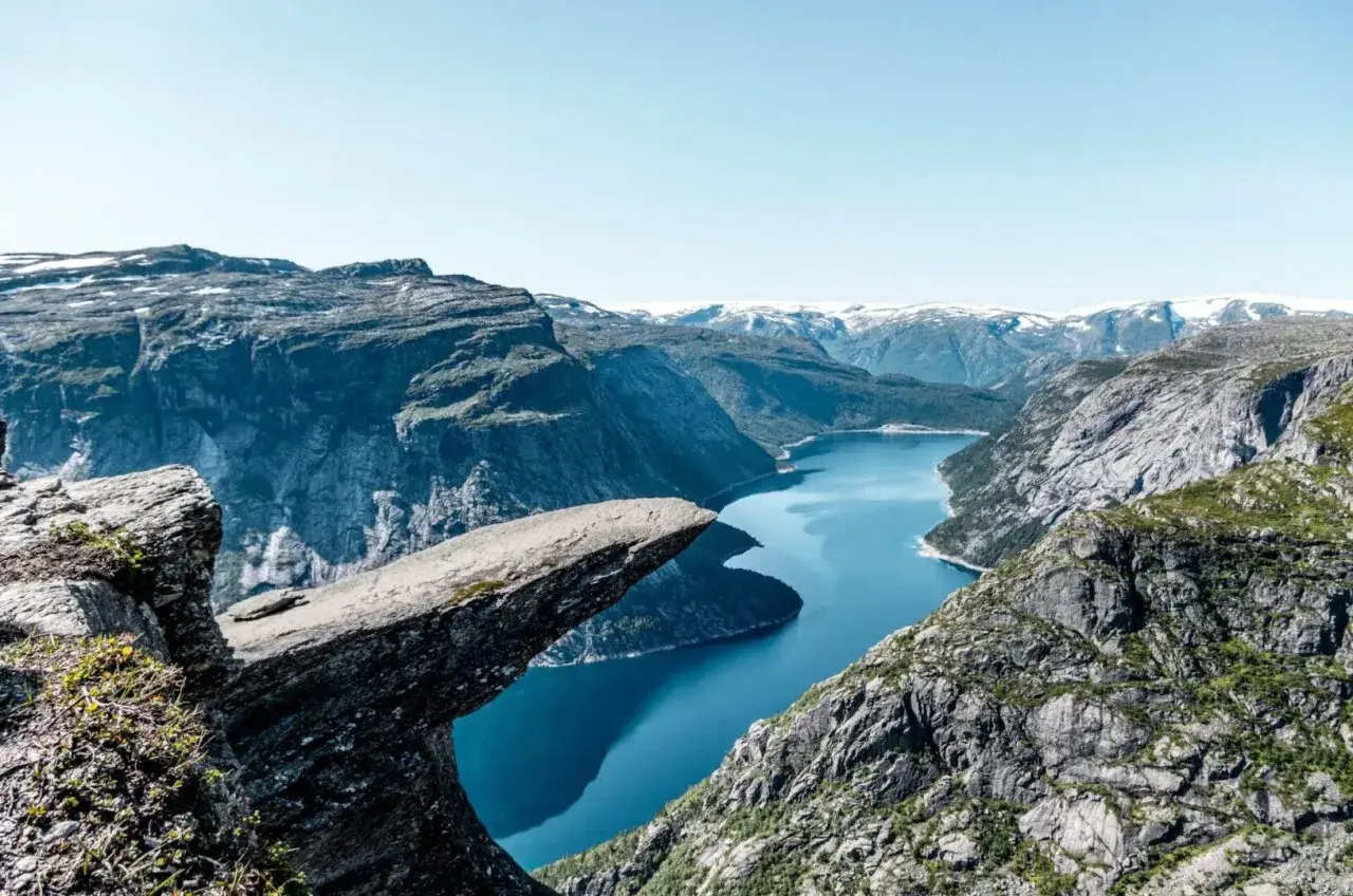 Niesamowite fiordy norweskie z wiszącą skałą Trolltunga, otoczone stromymi górami i krystalicznie czystą wodą.