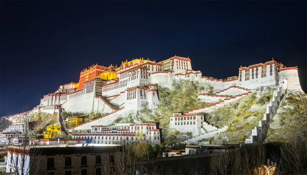 Nocą oświetlony Pałac Potala, symbol Tybetu stolicy, wznosi się majestatycznie na wzgórzu.